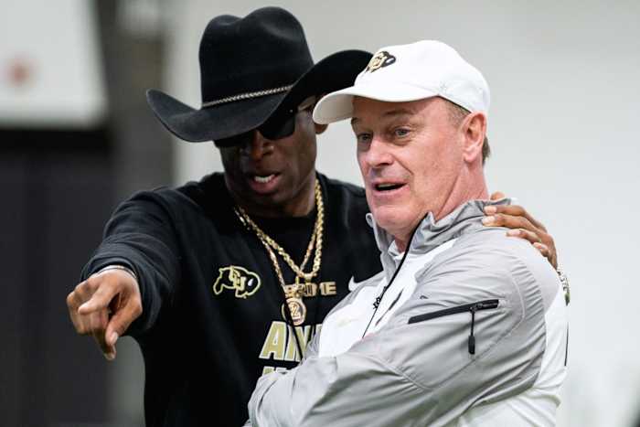 Deion Sanders talks to Rick George at CU practice